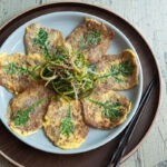 Yukjeon (Korean beef pancakes) are served with pachae salad