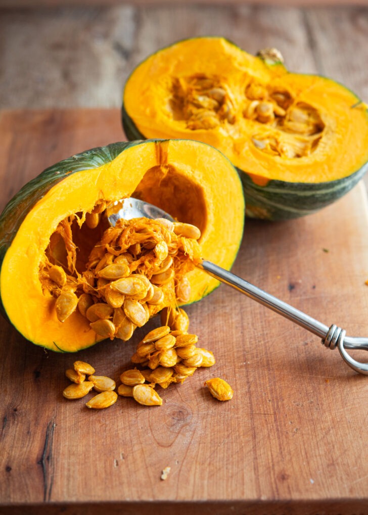 Kabocha squash seeds are removed with a spoon