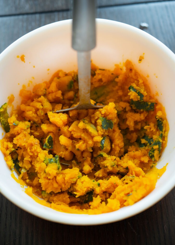 Steamed soft kabocha mashed in a bowl.