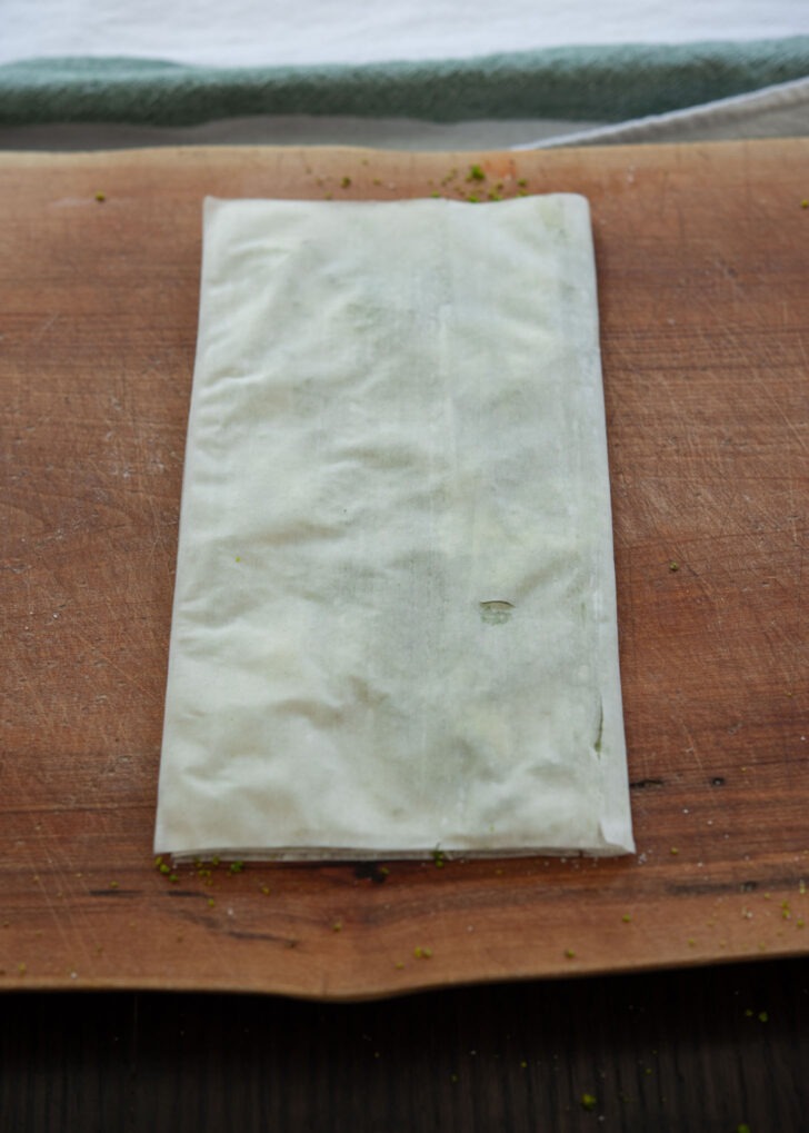 Filo pastry sheet folded to create envelope shape.