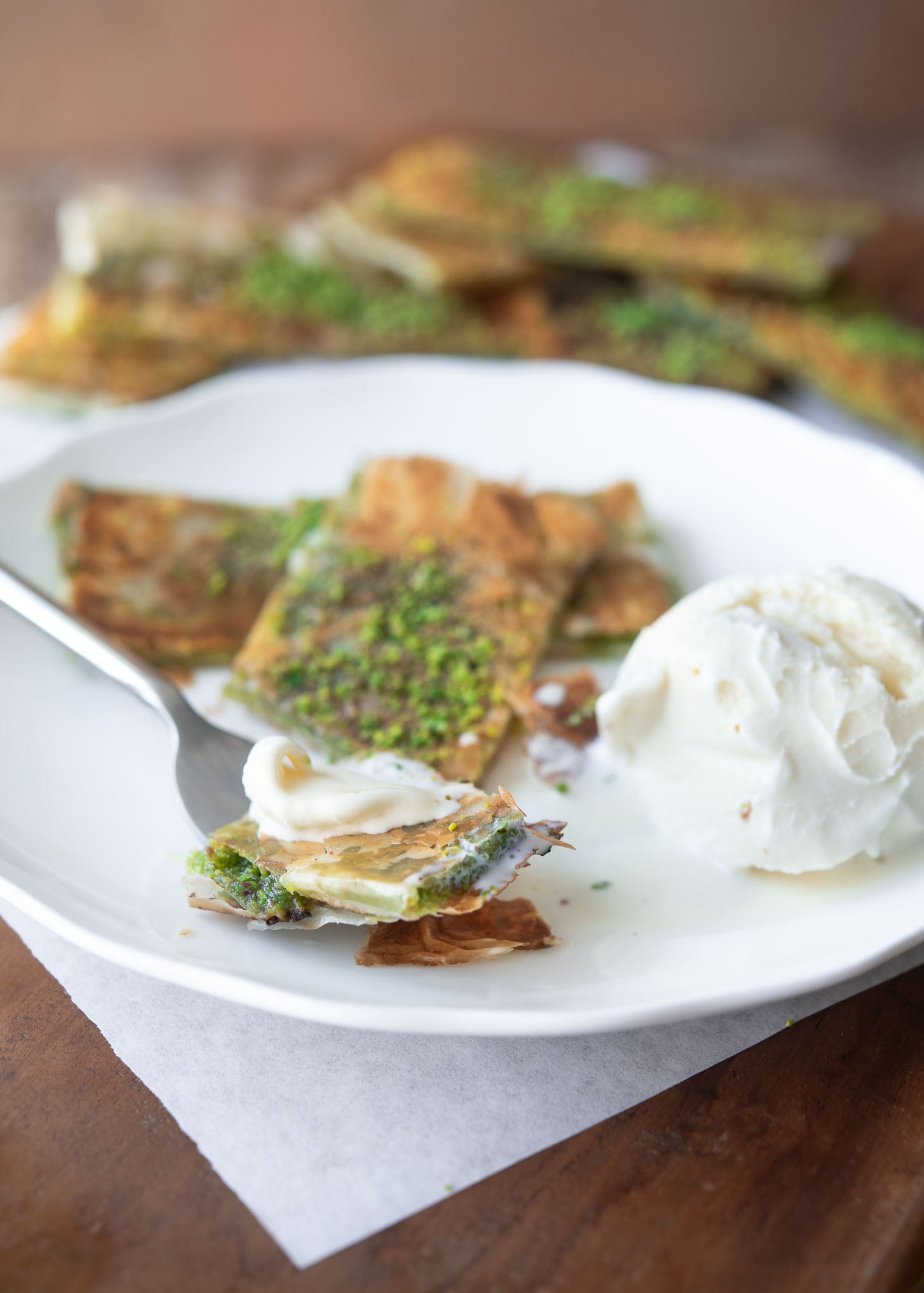 Pistachio Katmer dessert served with vanilla ice cream.