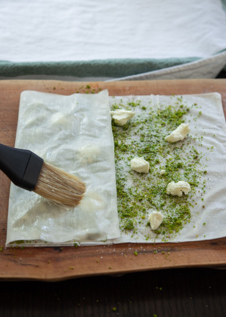 One side of Filo sheet folded over pistachio and clotted cream filling.