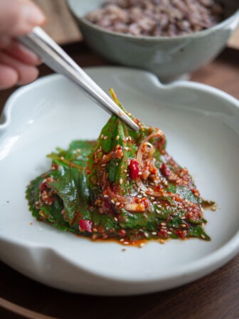 Perilla leaf kimchi known as Kaennip kimchi using chopstick to serve