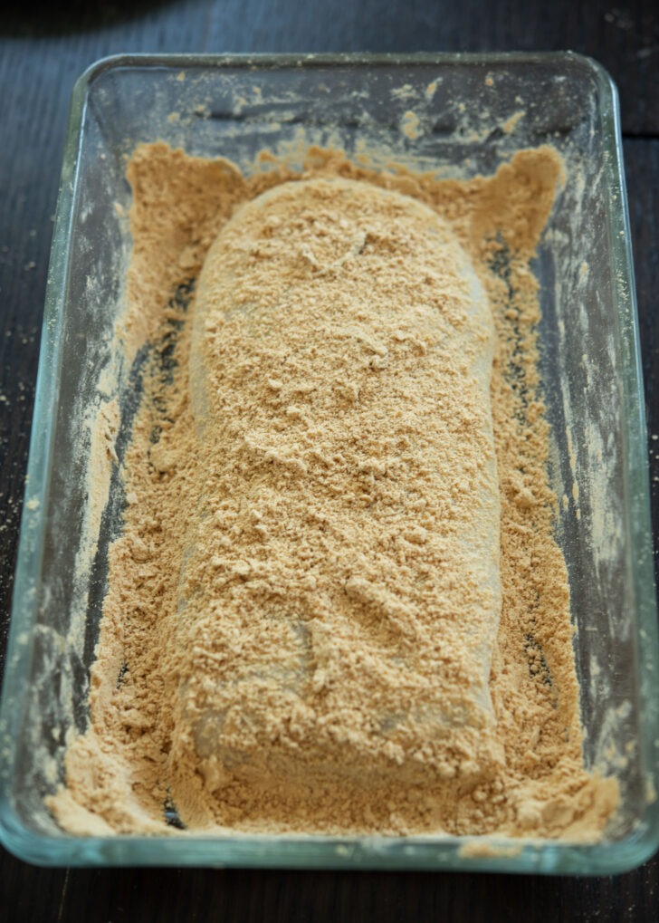 Sticky sweet rice dough is formed to coat with injeolmi powder