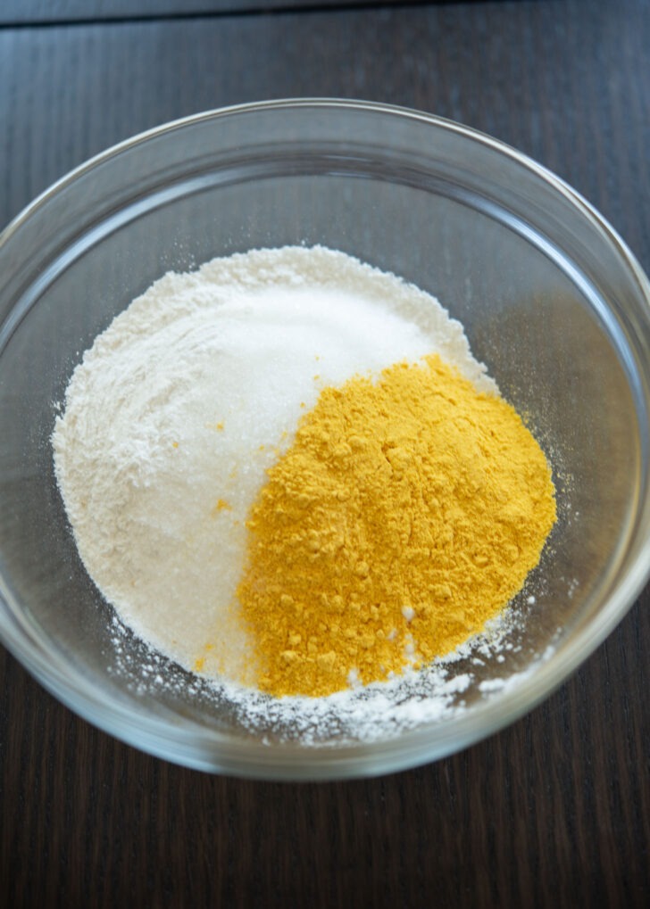 Pumpkin powder added to sweet rice flour mixture in a bowl.