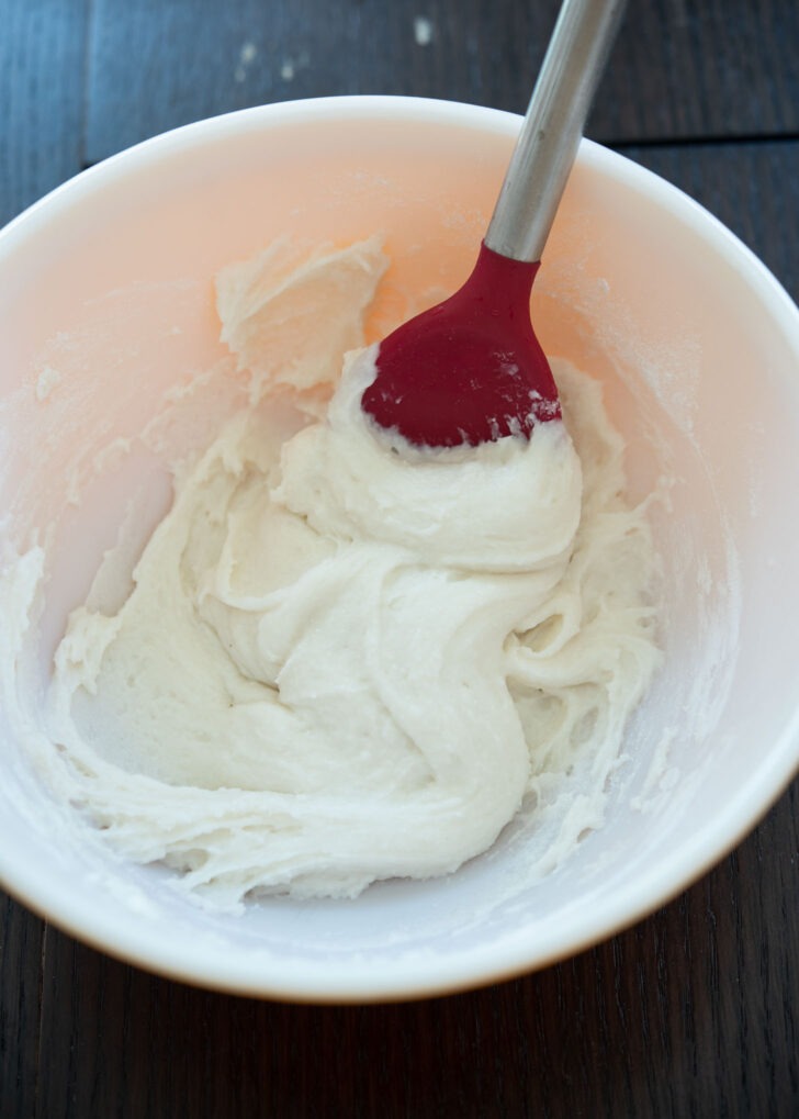 Korean sweet rice cake dough is mixed by a spoon.