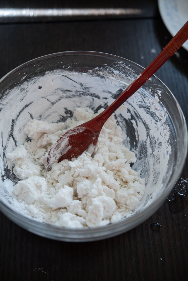 Rice flour and hot water mixed with a spoon.