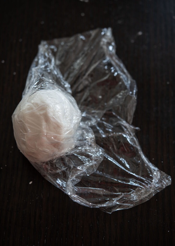 Songpyeon dough ball is covered with a plastic wrap.