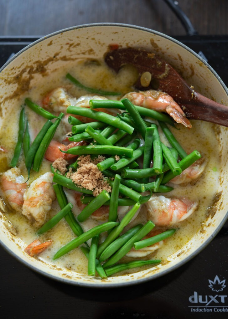 Fresh green beans and brown sugar added to shrimp and coconut milk mixture.