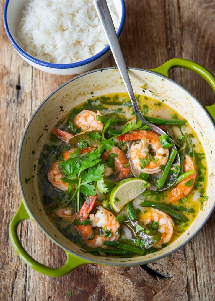 Top view of a pot of shrimp curry made with Thai green curry paste and green beans.