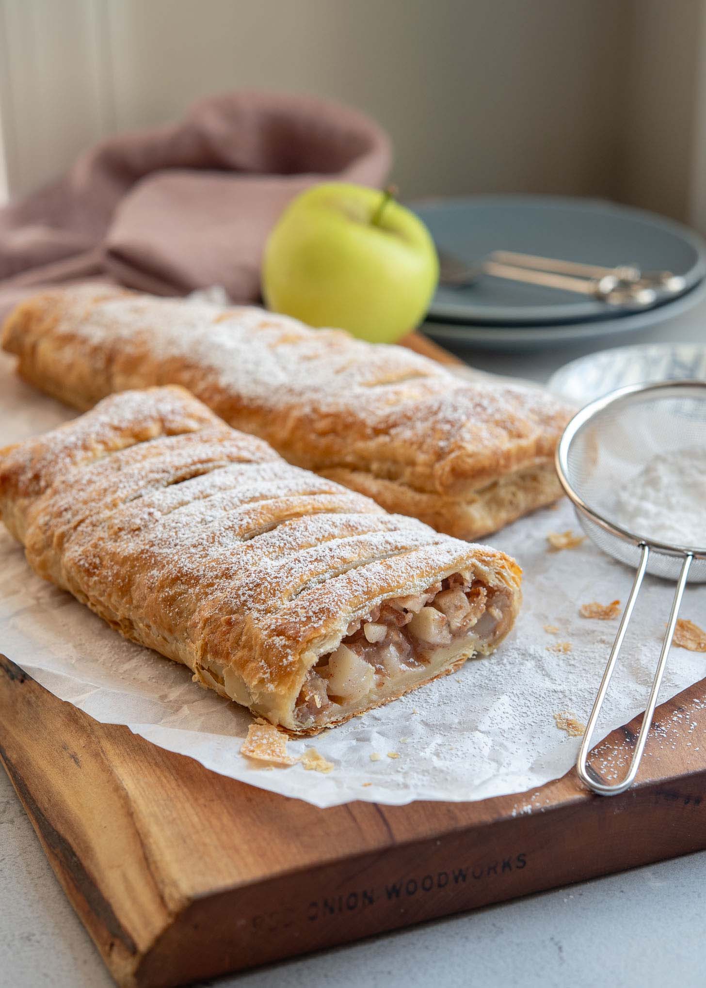 Sliced apple strudel showing apple filling inside.