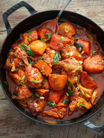 A pan filled with spicy Korean chicken stew with vegetables.