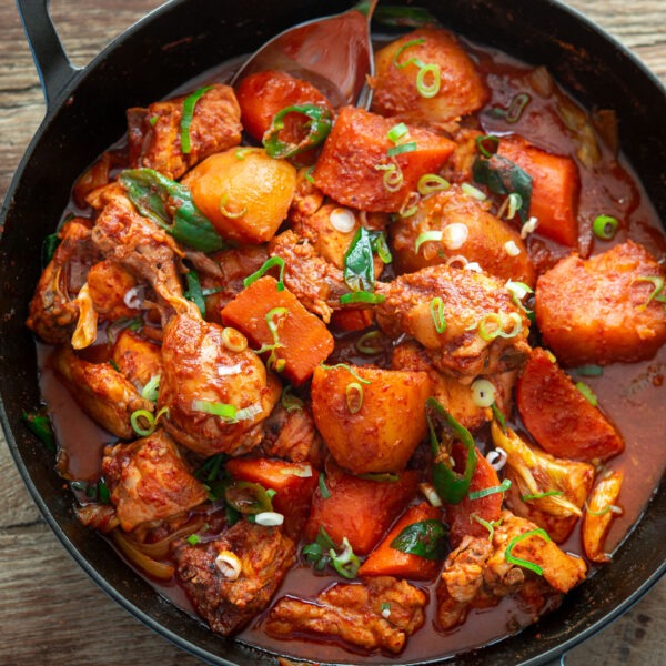 A pan filled with spicy Korean chicken stew with vegetables.