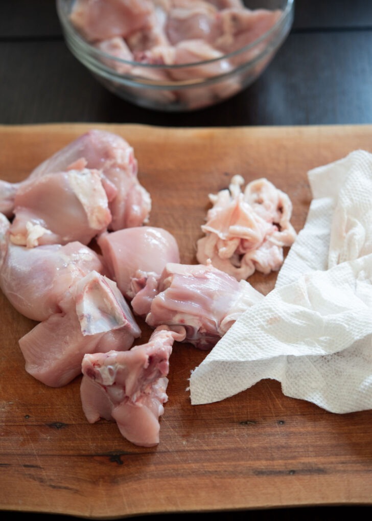 Chicken skin are removed by using a piece of paper towel.