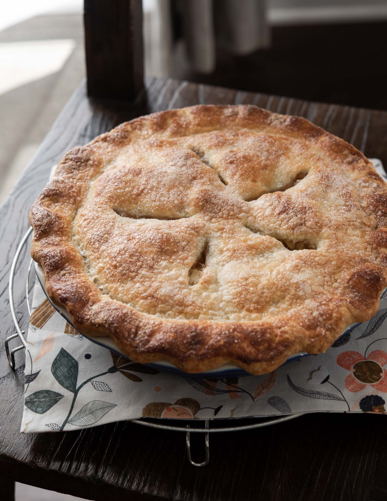 A deep dish apple pie with golden brown crust.