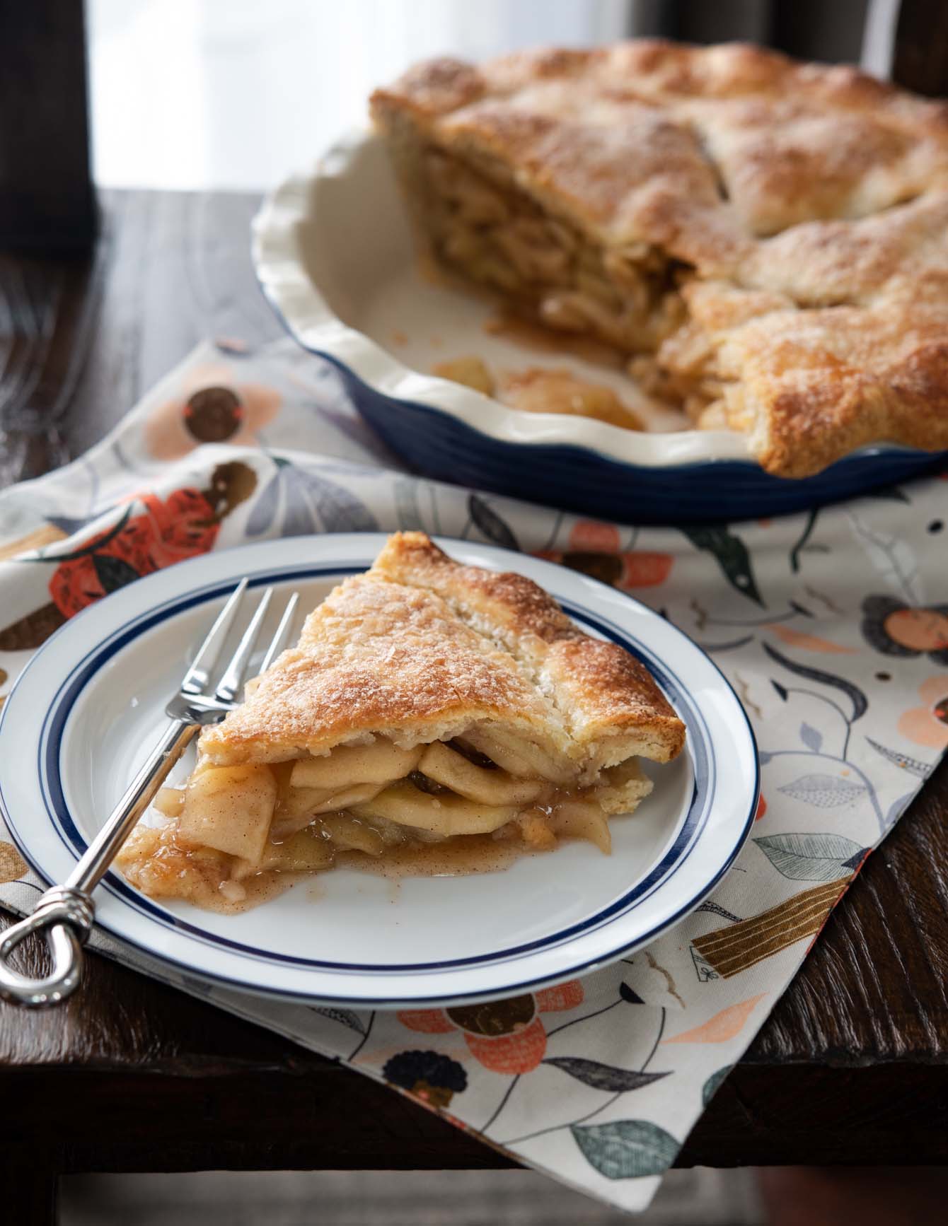 A slice of deep dish apple pie on a plate.