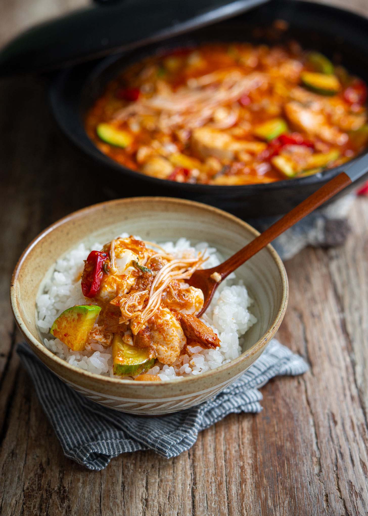 Sundubu jjigae made with tuna served over a bowl of rice.