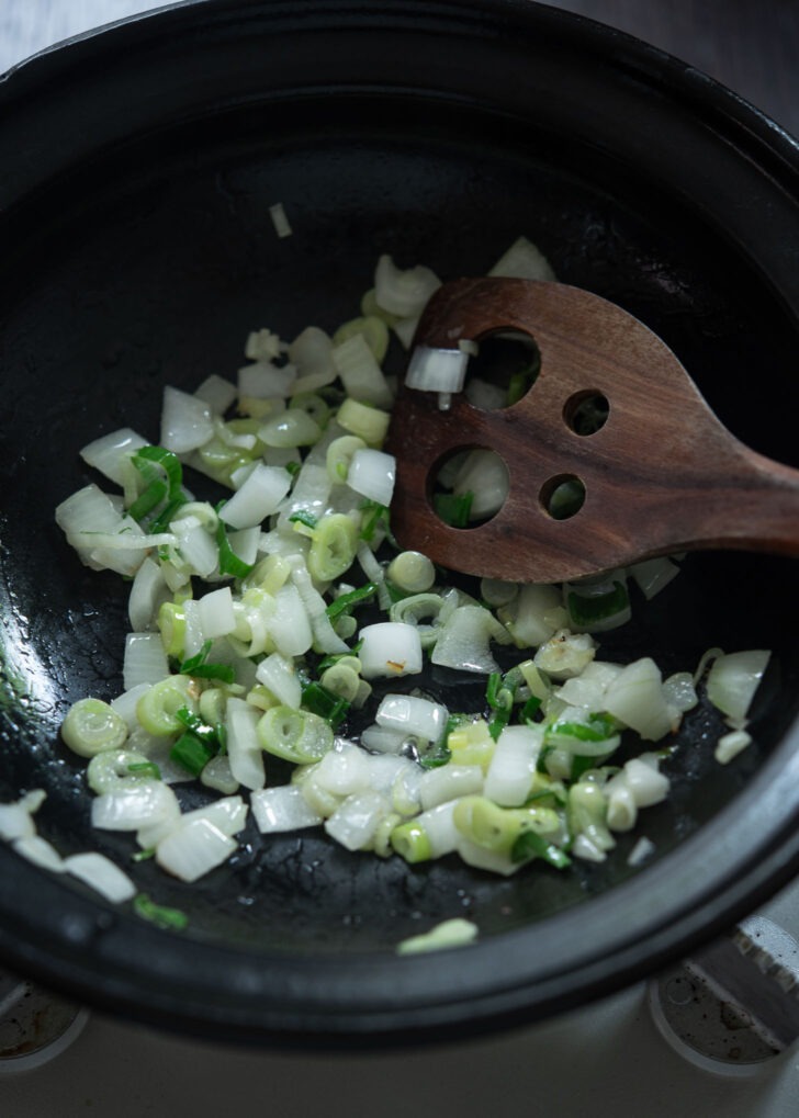 Onions cooking in a pot to make sundubu jjigae.