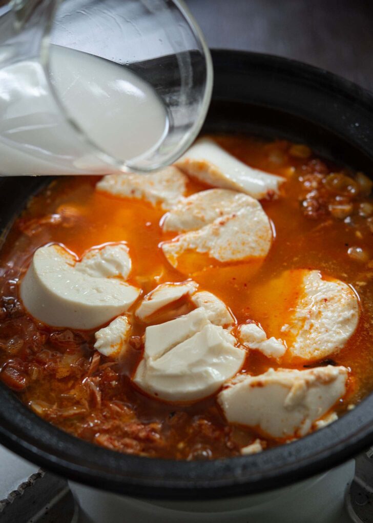 Silken tofu and rice water added to make tuna sundubu jjigae.