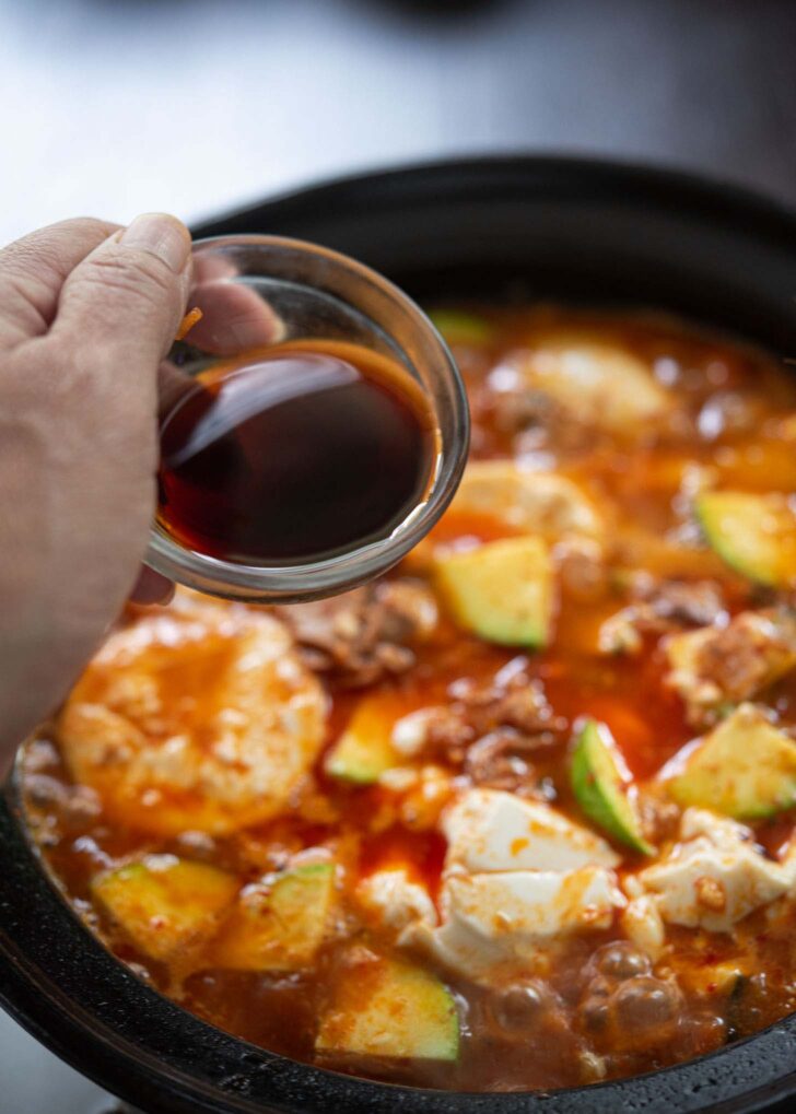 Korean soup soy sauce added to season sundubu jjigae.