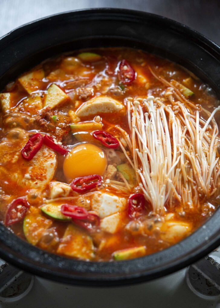 Mushroom and raw egg added at the end of cooking of Korean tofu soup.