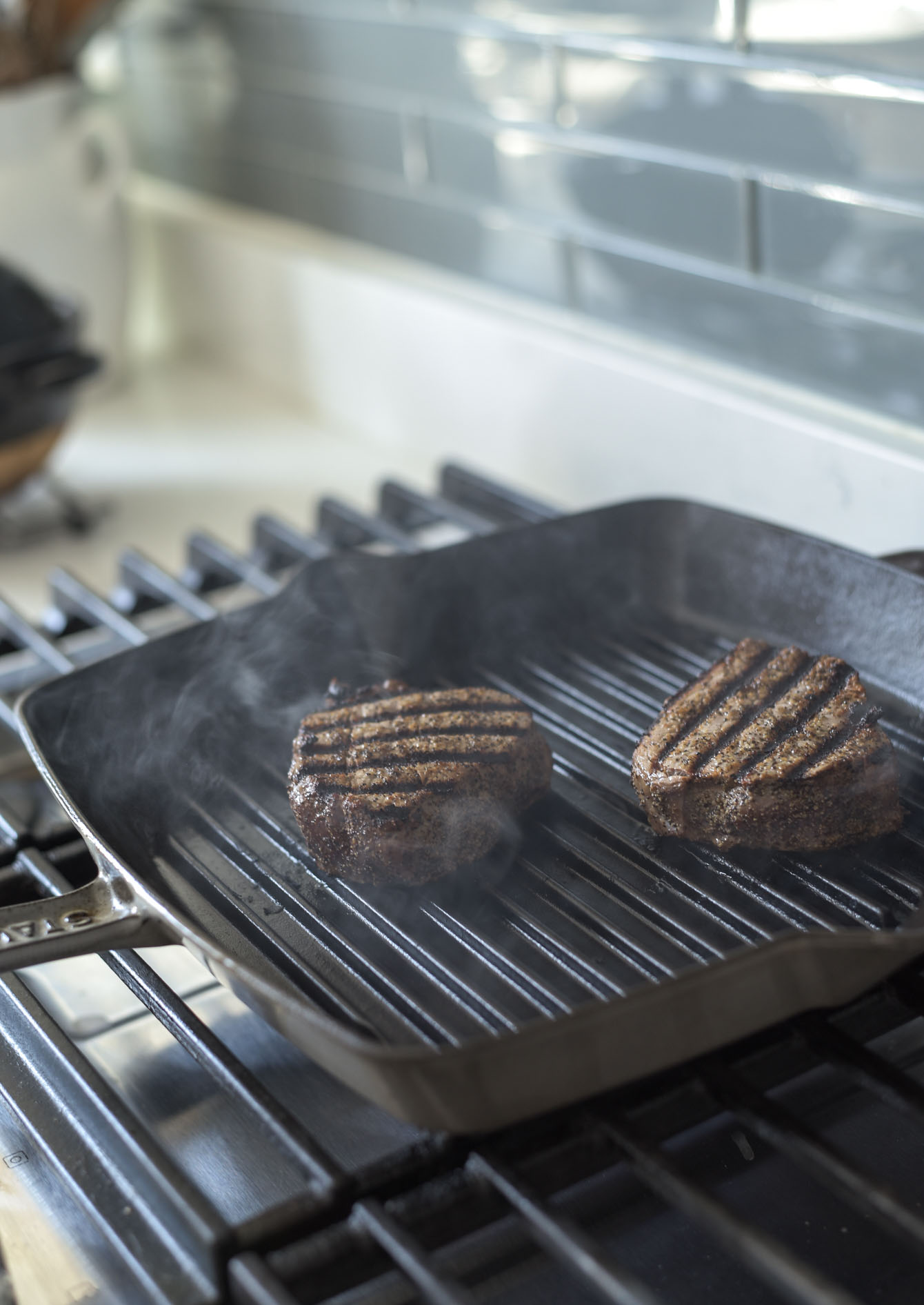 Beef tenderloin grilling in a pan for making Thai beef salad.