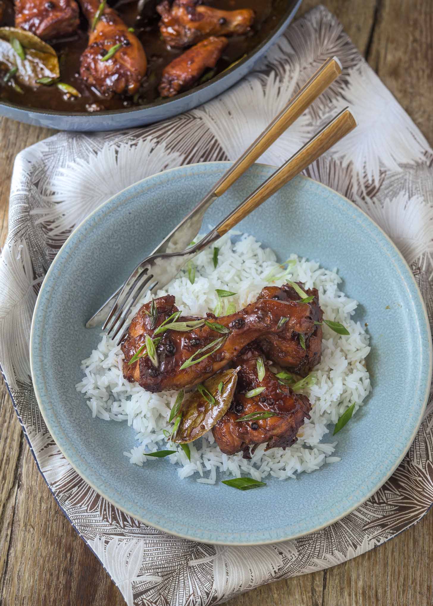 Filipino chicken adobo served over rice in a bowl.