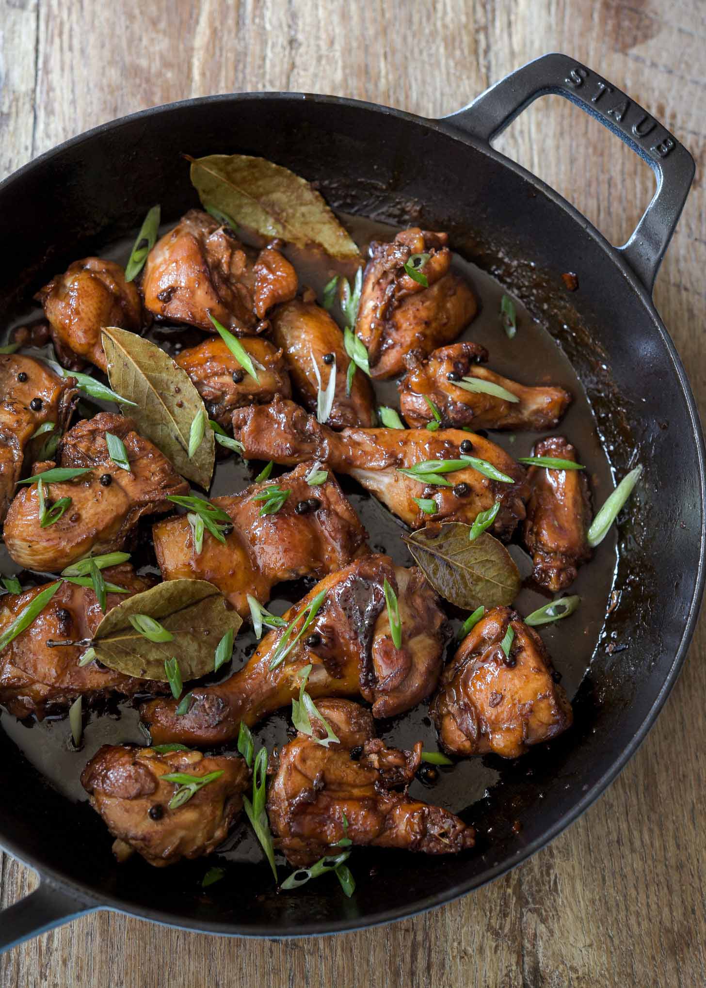 A skillet filled with Filipino chicken adobo.