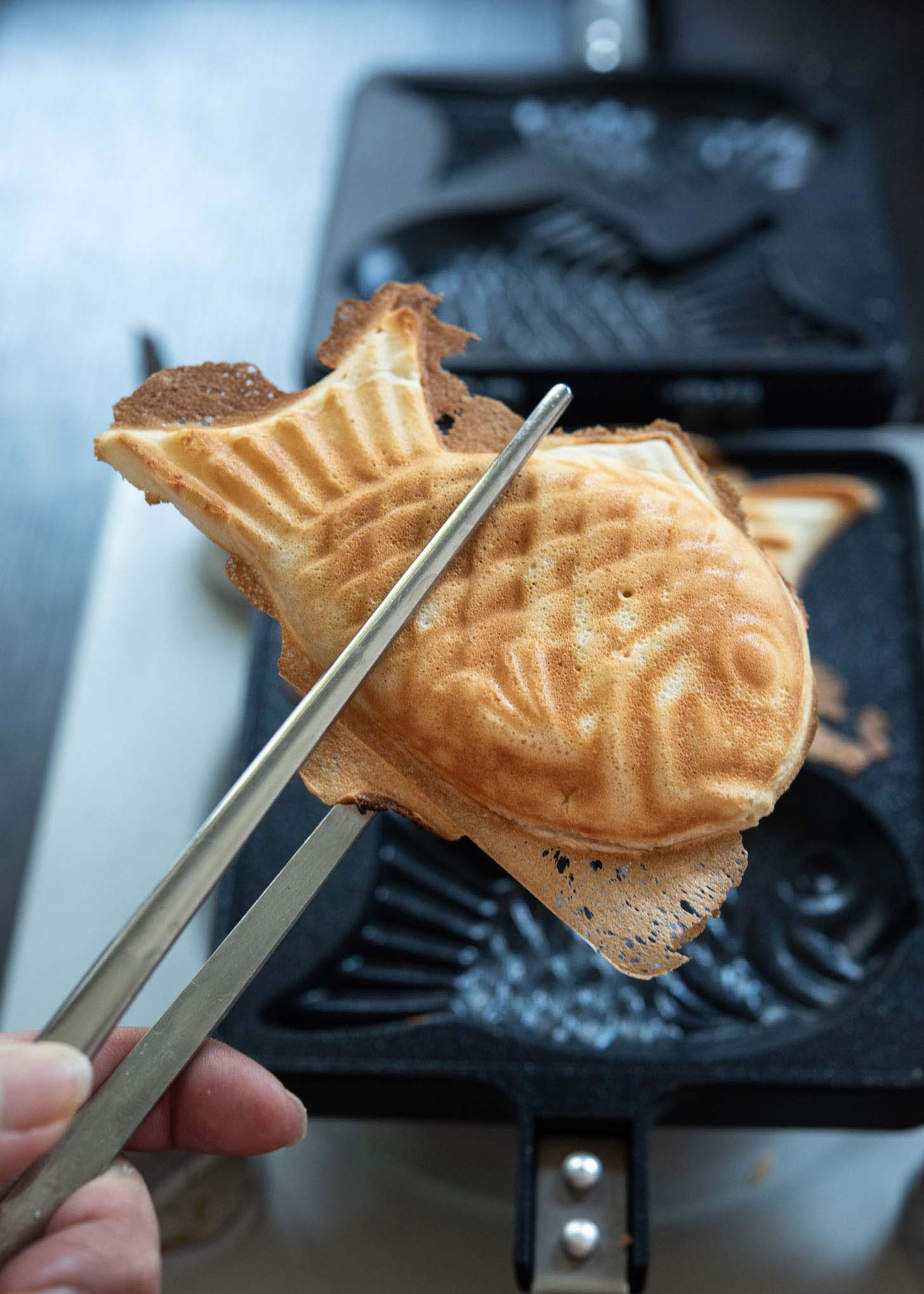 Golden brown baked bungeoppang out of fish shaped mold.