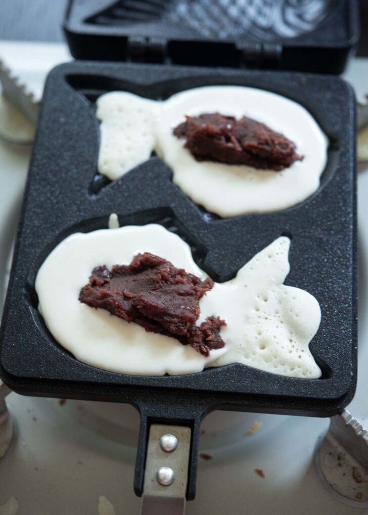 Sweet red bean filling placed on top of batter.