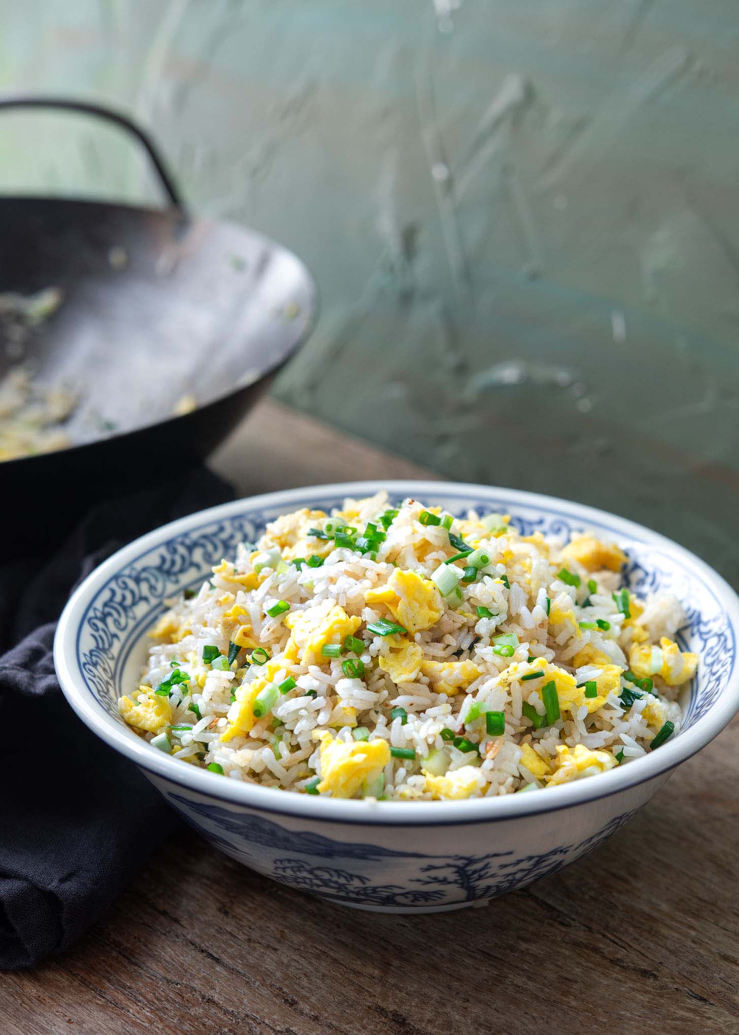 Egg fried rice in a blue and white serving bowl.