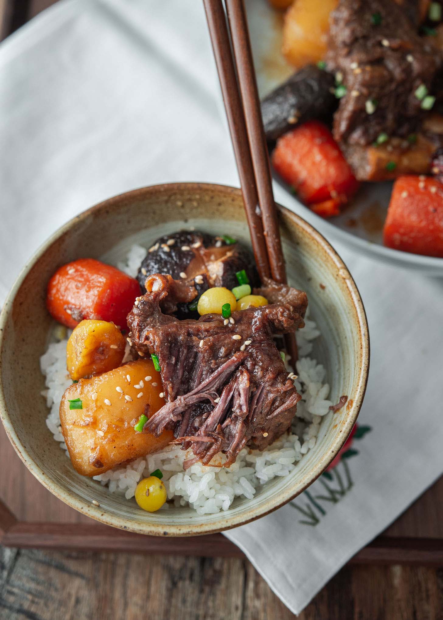 Korean braised beef with vegetables on a bowl of rice.