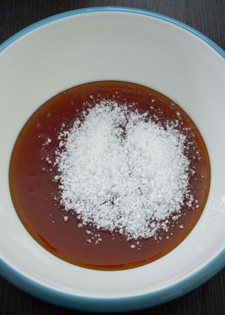 Korean rice syrup and coarse salt combined in a mixing bowl.