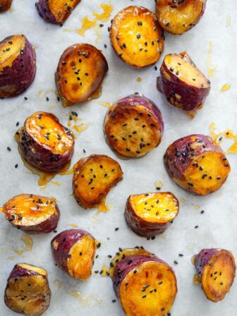 Candied Korean sweet potato with crunchy shell on parchment paper.