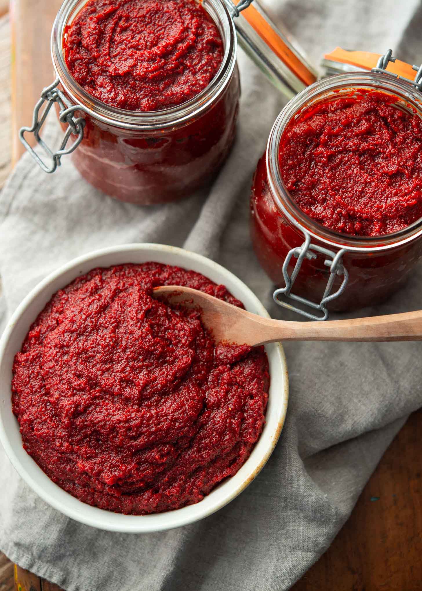 Korean chili paste in a bowl and glass jars.