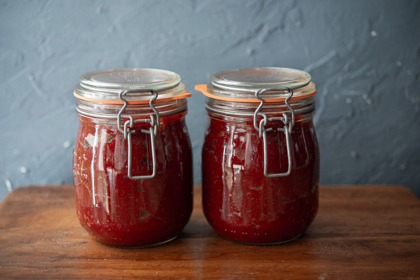 Two glass jars of gochujang paste.