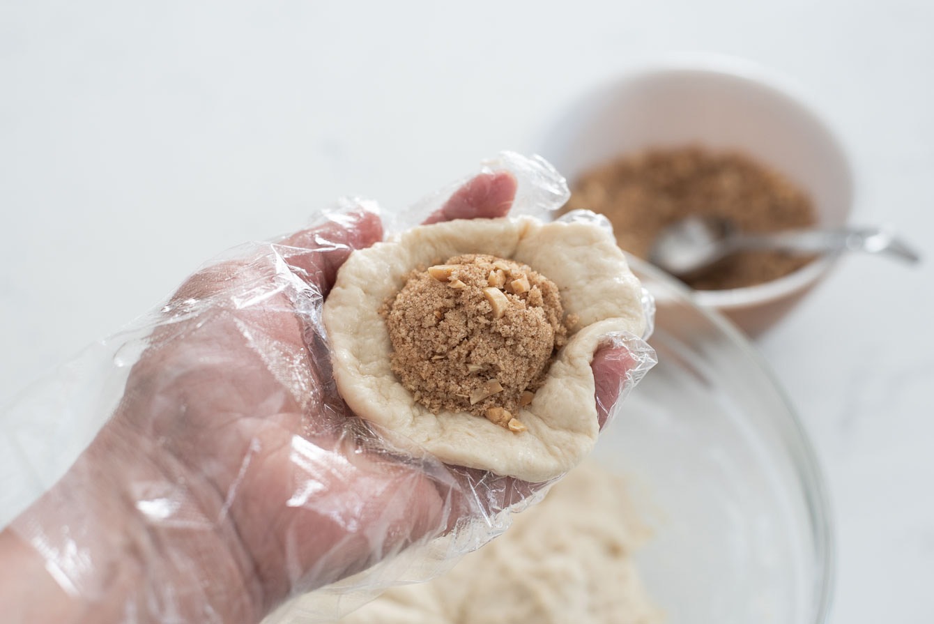 Brown sugar filling added to the center of flatten hotteok dough.
