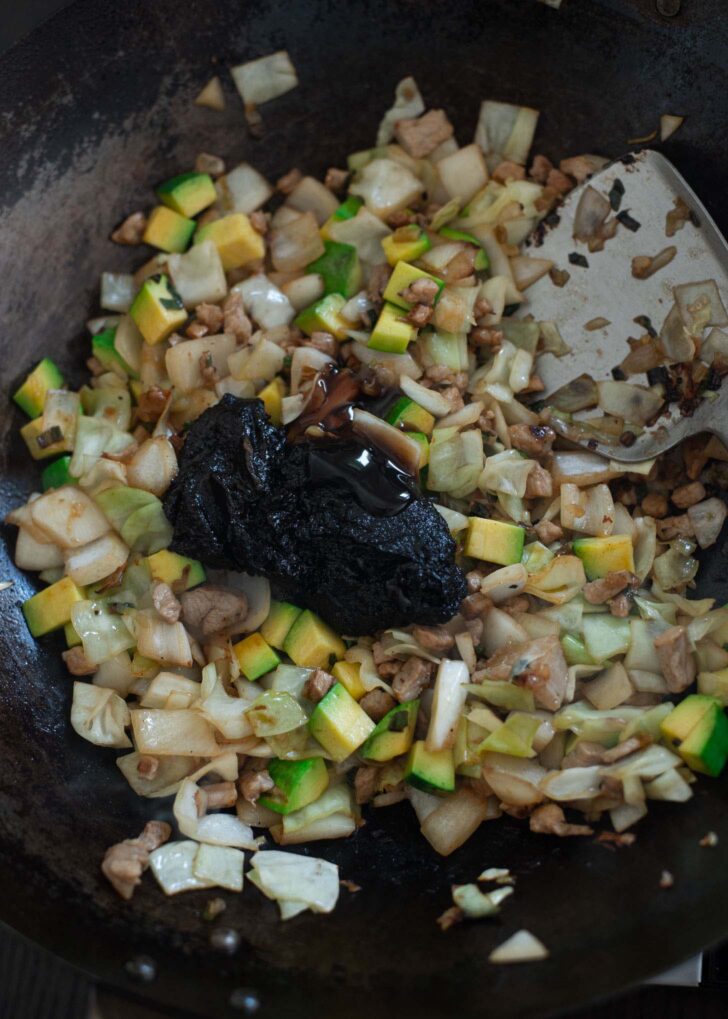 Fried chujang paste and oyster sauce is added to the pork and vegetable mixture.