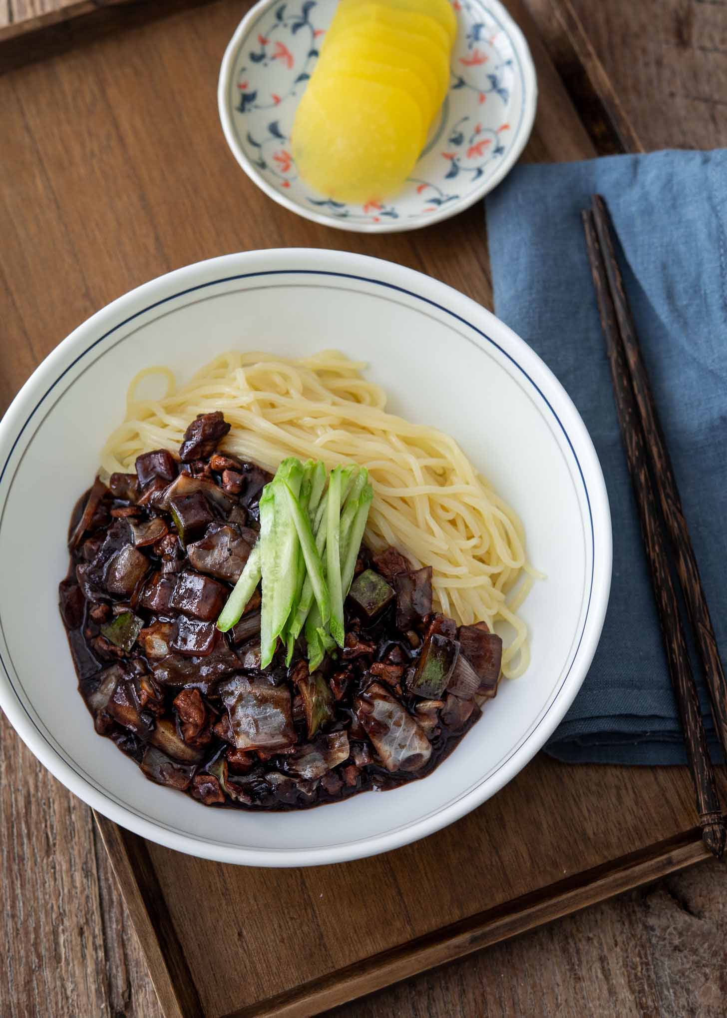 A bowl of jajangmyeon (Korean black bean noodles) in a serving dish.
