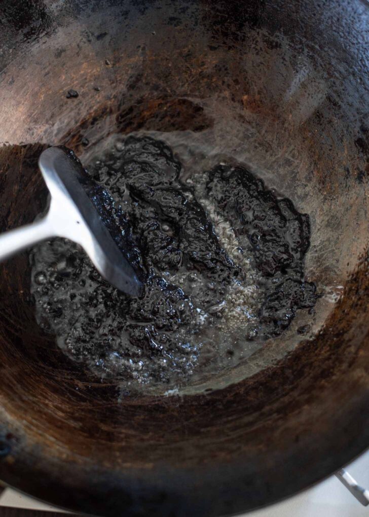 Korean black bean paste fried with oil in a wok.