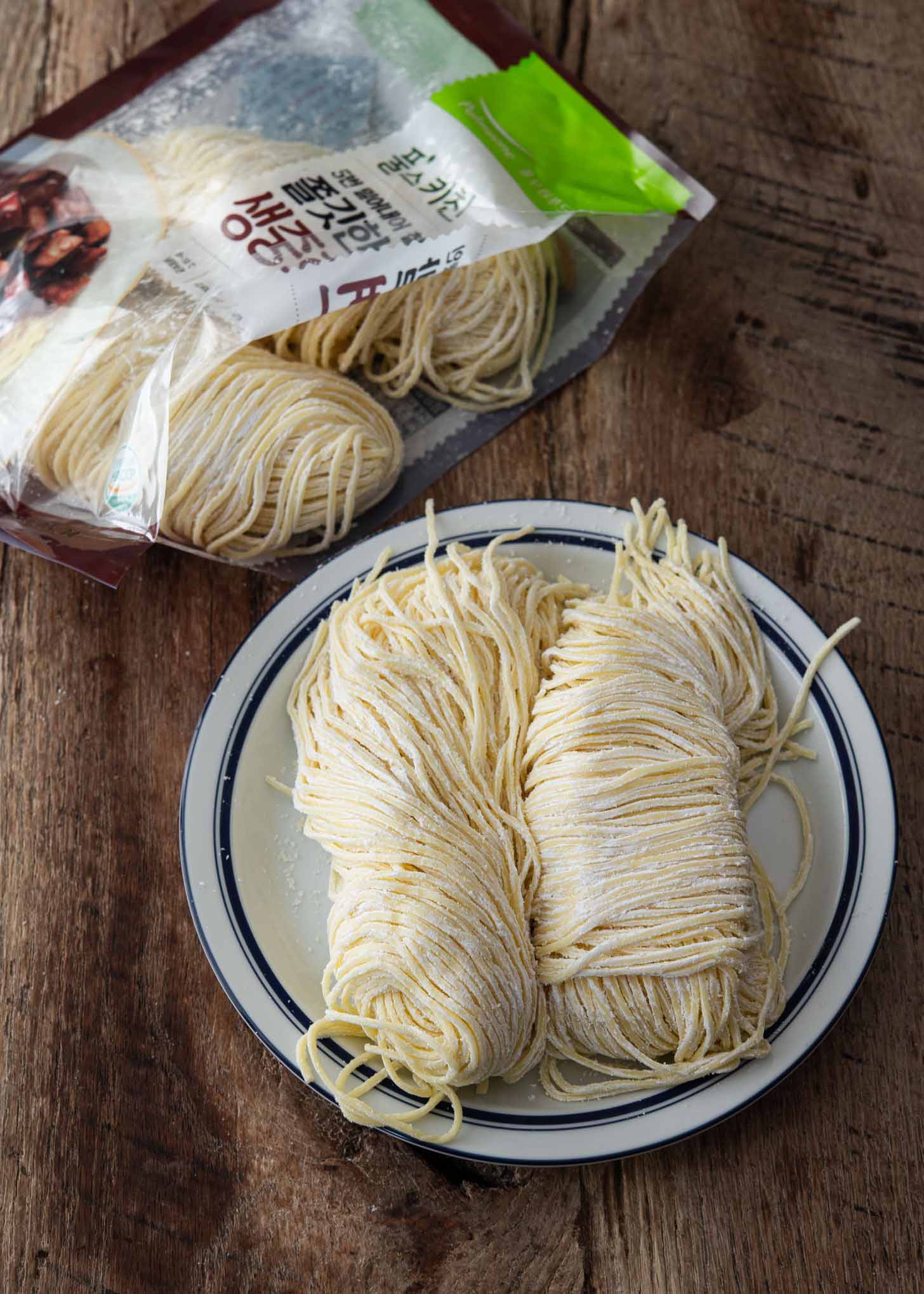 Two bundles of Korean wheat noodles for jajangmyeon recipe.