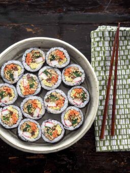 Kimbap slices are beautiful arranged in a serving dish.