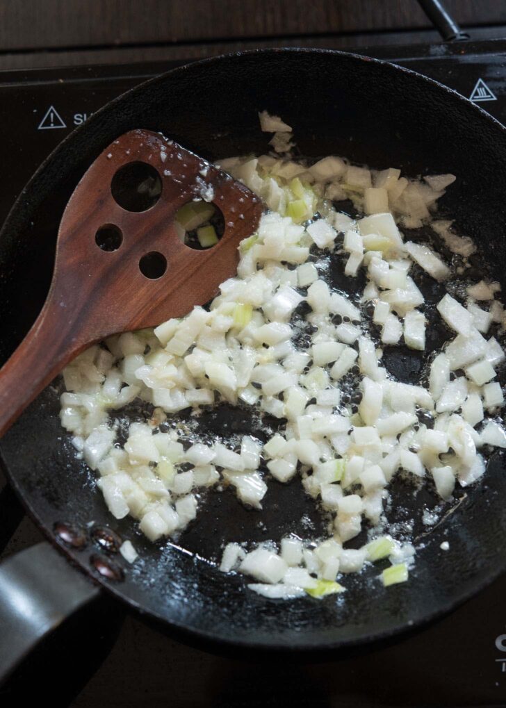 Onion and garlic cooking in a skillet.