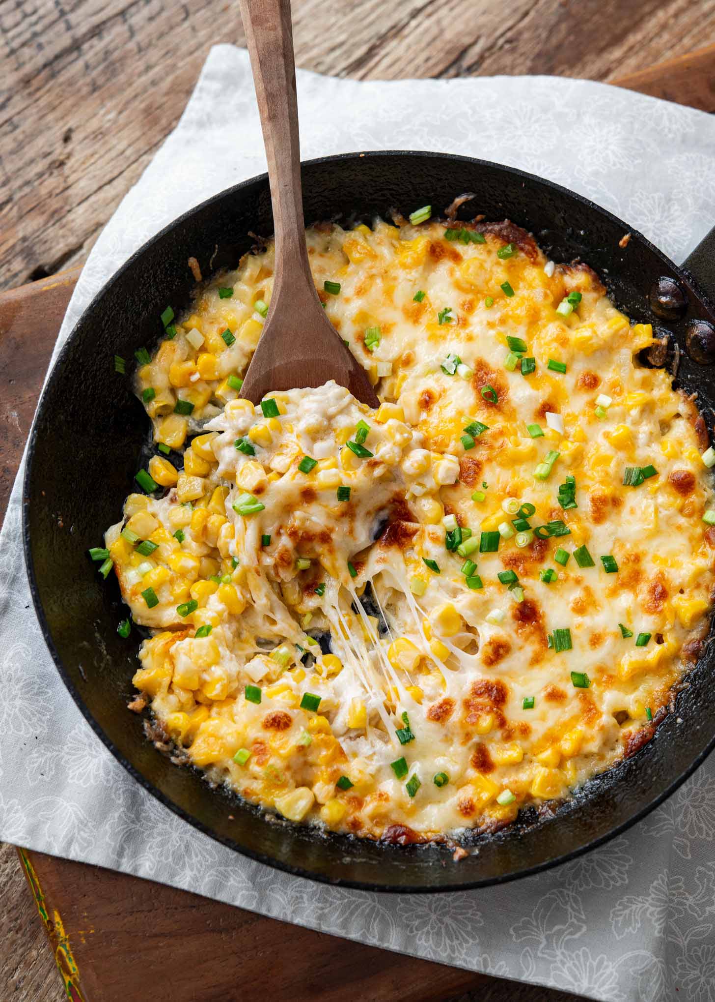 Korean corn cheese baked in a cast iron skillet.