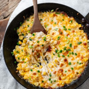 Cheesy Korean corn cheese baked in a cast iron skillet.