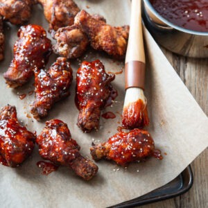 Gochujang sauce glaze brushed on crispy Korean fried chicken wings.