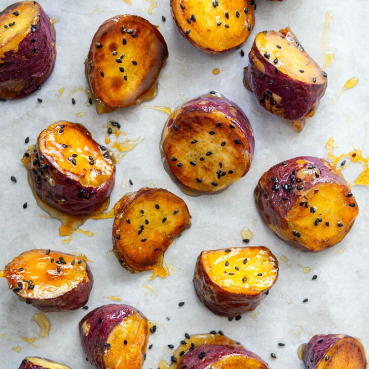 Candied Korean sweet potato with crunchy shell on parchment paper.