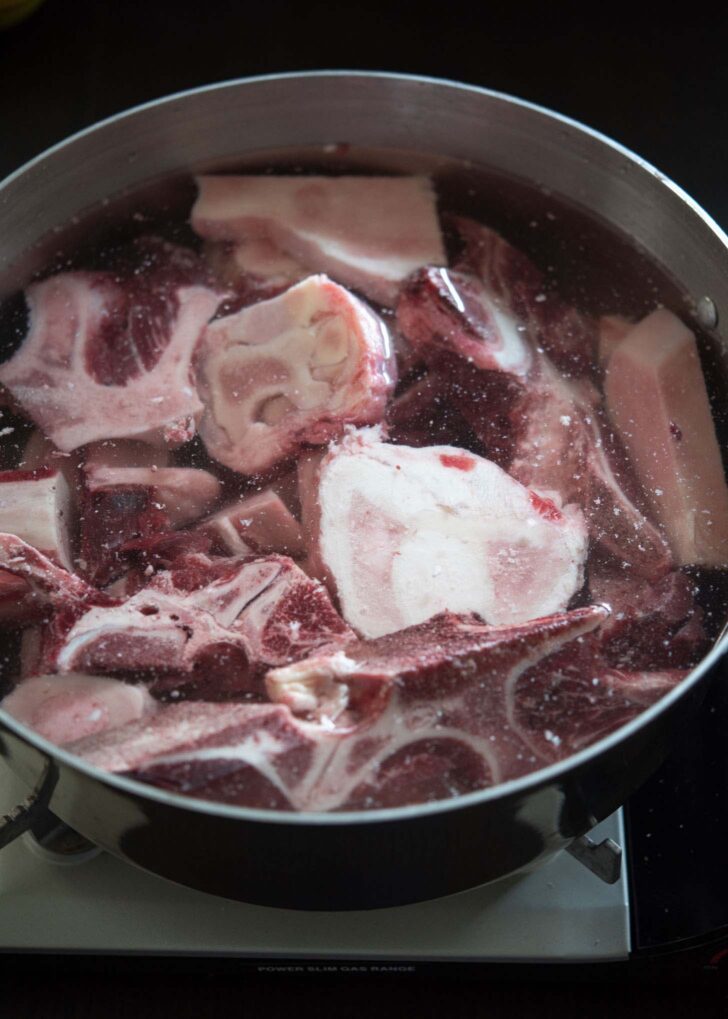 Beef bones covered with water in a large pot.