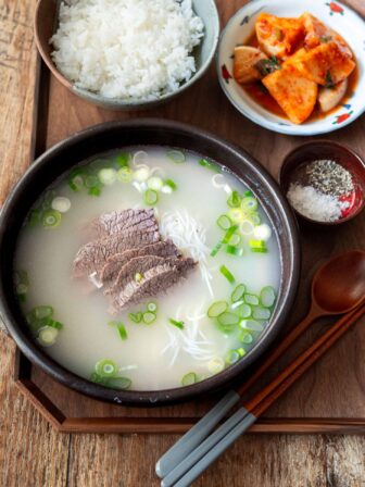 A bowl of seolleongtang with rice and radish kimchi.