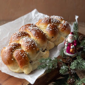 Braided Finnish cardamom bread (Pulla) next to Christmas ornaments.
